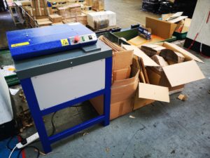 A pile of cardboard boxes in a warehouse.